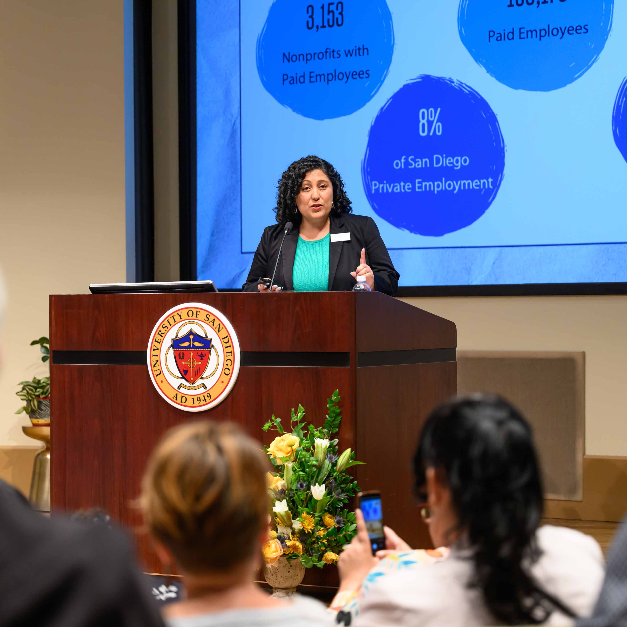 Cristina Sanchez-Kerr speaking at a podium.
