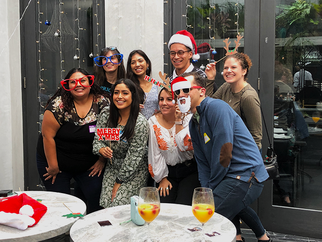 Group of students standing together dressed in holiday attire for Christmas.