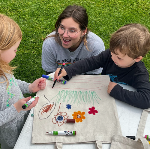 image of group and a child painting bags
