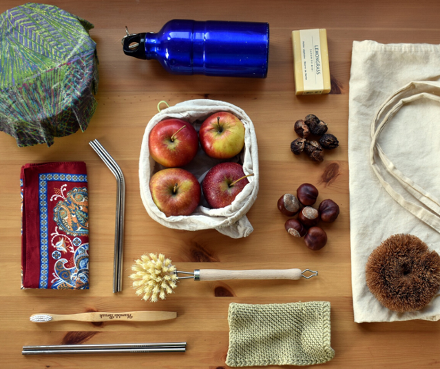 A zero waste kit including a water bottle, metal straws, cloth napkins, etc.