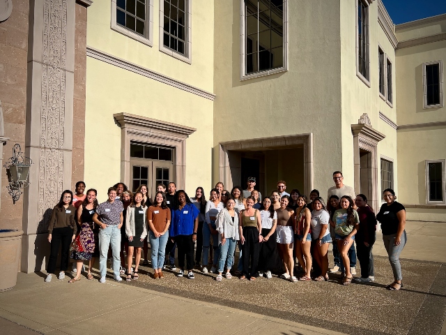 Group of young students standing together for a group photo