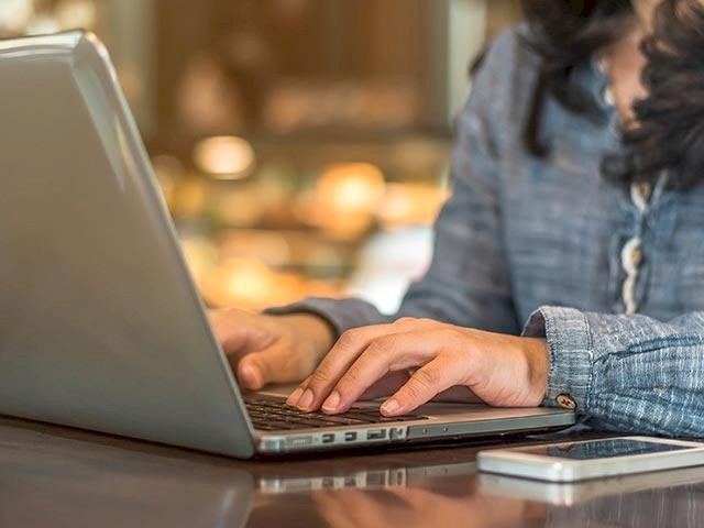 someone typing on a laptop