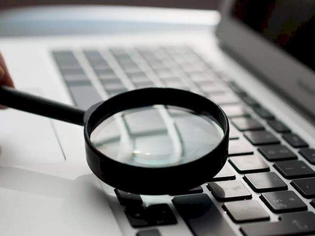 a magnifying glass on a laptop keyboard