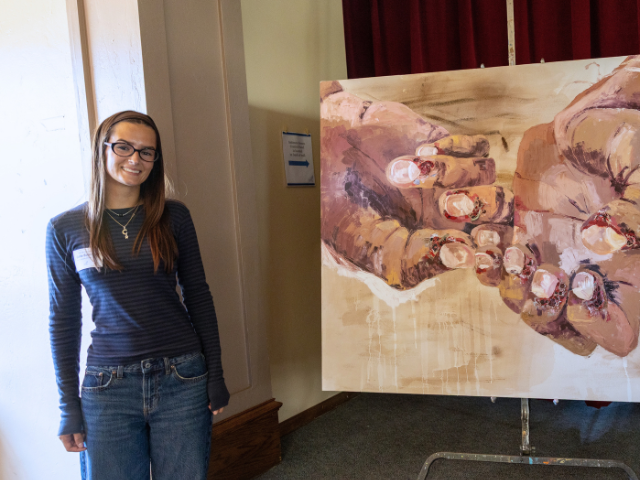 student presenting painting