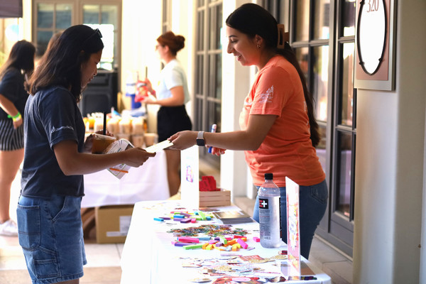 Student Leader showing another Student a flyer