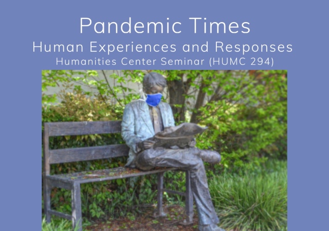 Statue of a man sitting on a park bench wearing a cloth face mask