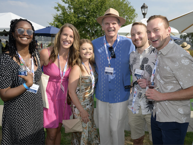 President Harris posing with attendees of a campus event