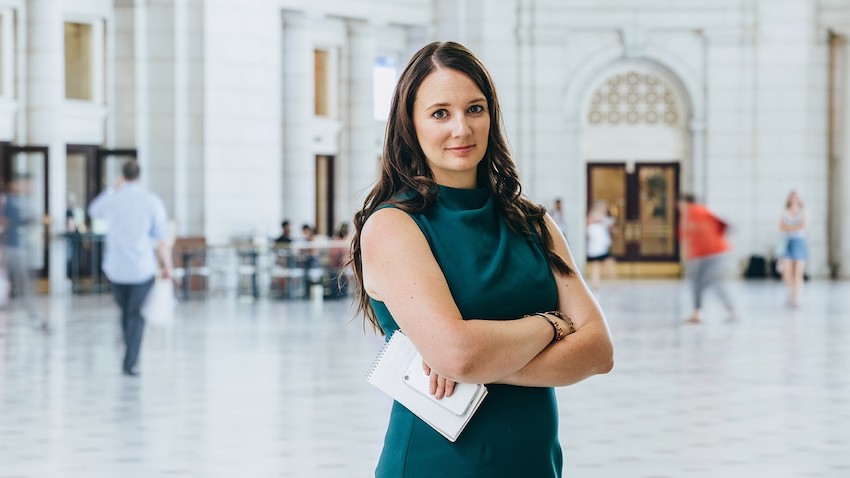 Natalie Andrews '11 poses with arms crossed at Utah State University