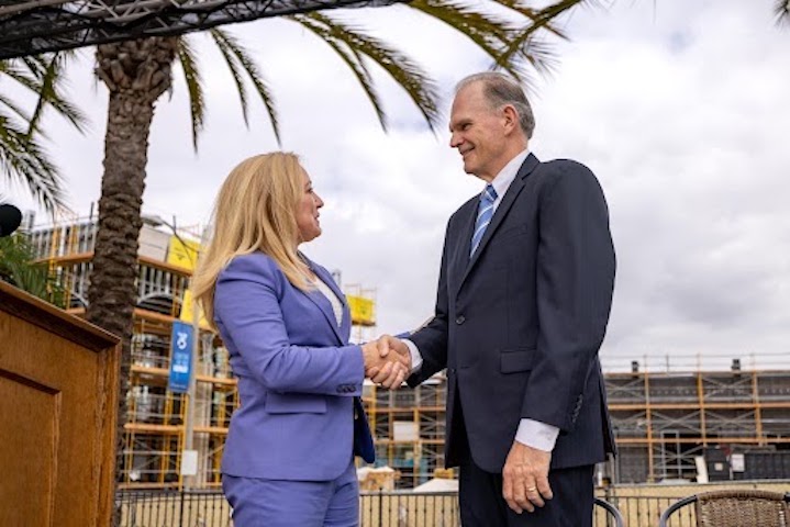 USD President James T. Harris and Palomar Health CEO Diane Hansen shake hands