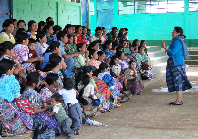 Women Waging Peace member speaking to a large group