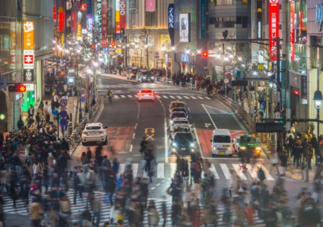 This is a picture of a busy Japanese city street. 