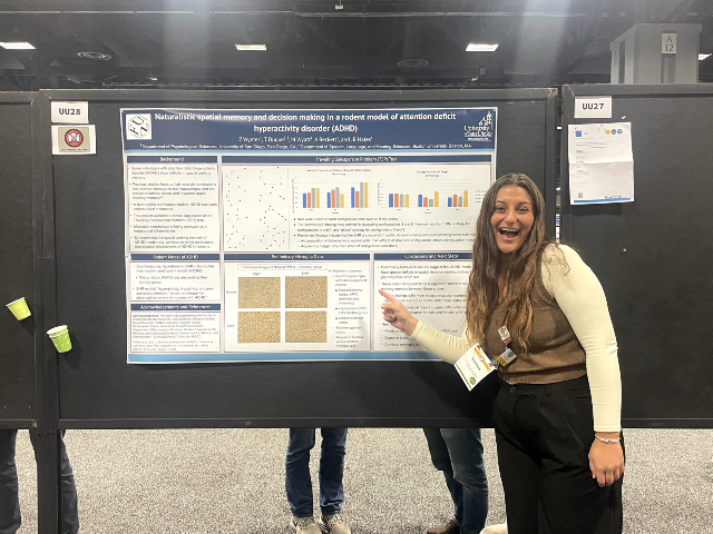 Madison Wyatt standing in front of her research poster