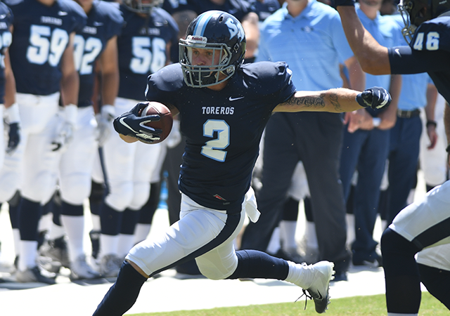 Christian Brooks runs with football