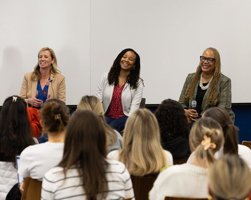 panelists laughing during presentation 