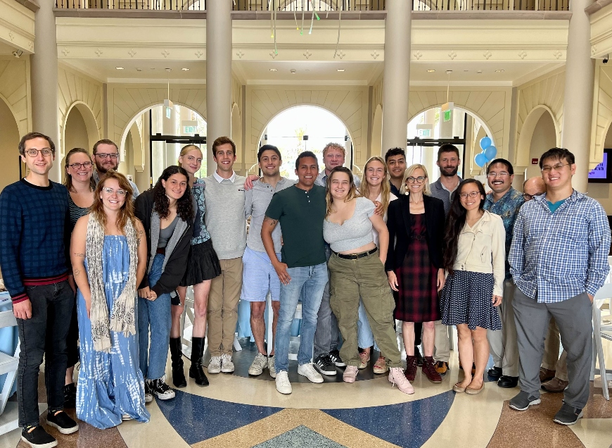 Group of faculty and students standing in atrium of science building