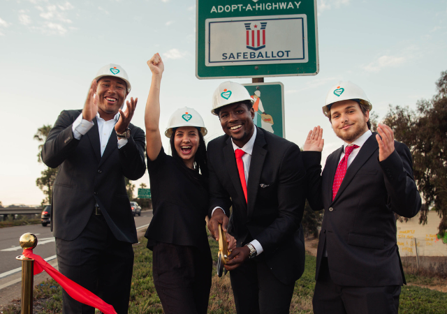 From left to right: Cordano Russell, Donatella Johnson, Elijah Johnson, and Thomas Salazar cut a red ribbon in celebration of adopting a highway.