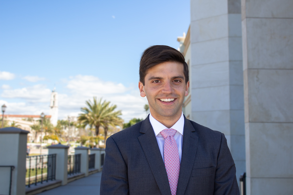 MBA student Daniel Atuesta standing in front of the Knauss Center for Business Education