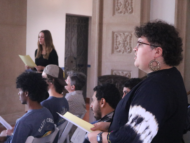 Image of student singing during Ensemble X performance Spring 2024.