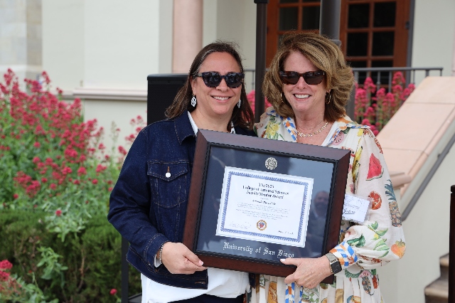 Dr. Ruiz and Dean Dorton pose with the Faculty Mentor Award. 