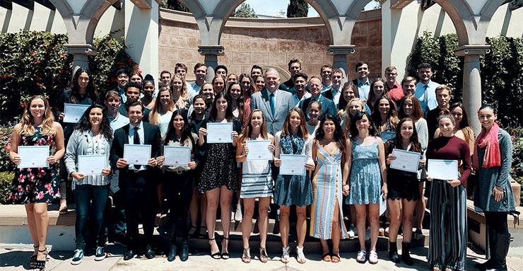 University of San Diego President James T. Harris III is surrounded by a bevy of outstanding USD Scholar-Athletes at a May 16 luncheon to honor them for their academic prowess.