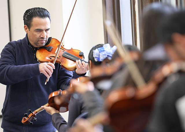 An instructor teaches mariachi
