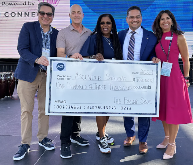 Check presentation, from left to right:  Daniel Fitzgerald, Executive Director, San Diego & Imperial SBDC; Wolf Bielas, Managing Partner of Downtown Works; Tara Lynn Gray, Director of CalOSBA; Jorge Muniz, Jr, co-founder of Ascender Systems, and Amy Duncan, Director of The Brink SBDC.