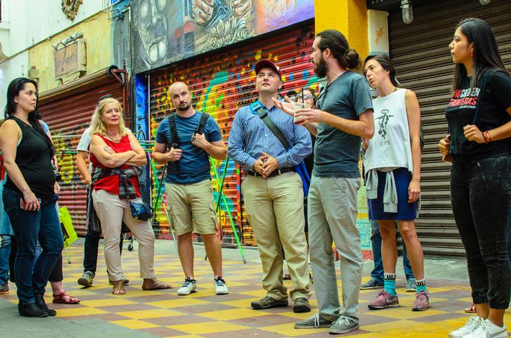 TransBorder Institute Director Ev Meade, center, and certificate program students visit Pasaje Rodriguez with Luis Montijo (third from right).