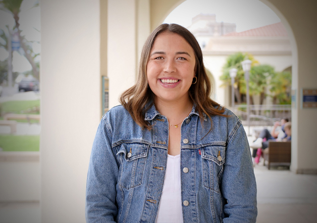 Tatum Garrison, recent business school graduate, standing near the UCs