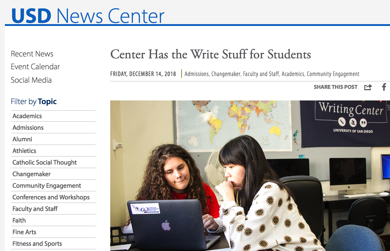 Two students working on assignment together in front of laptop computer