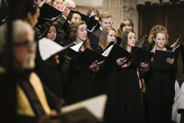 choral scholars singing in background, father gino sitting on the side