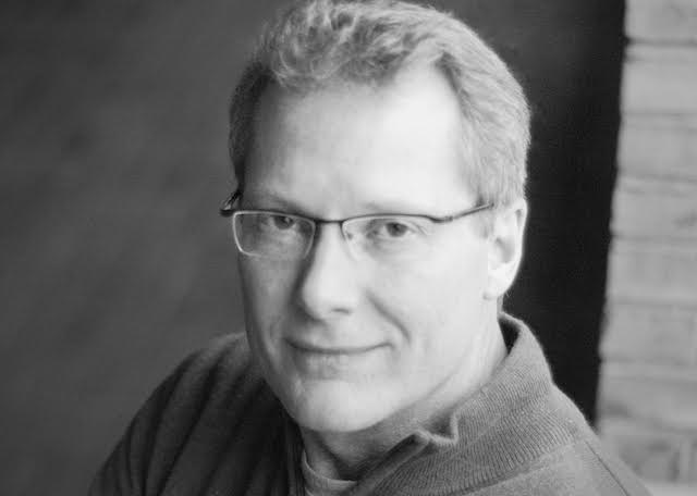 headshot of Kelly James Clark