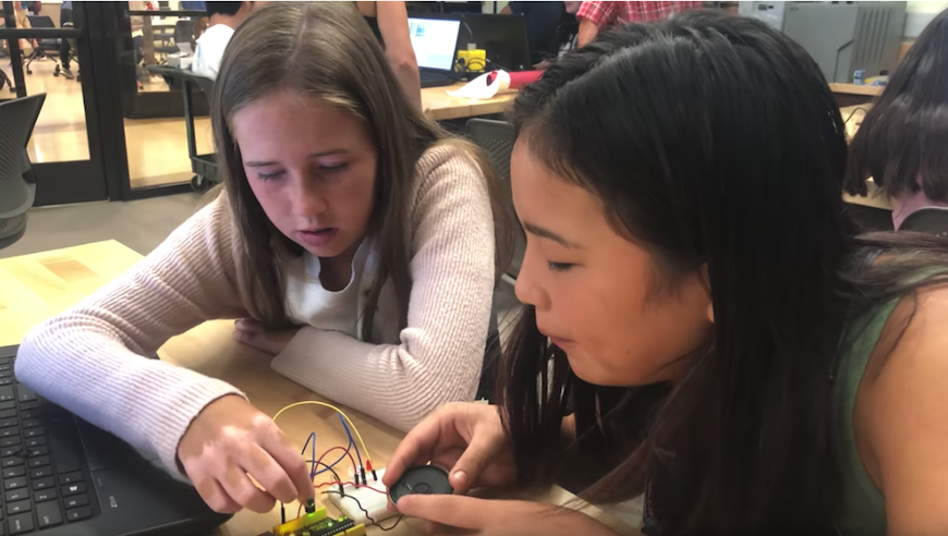 two students tinkering