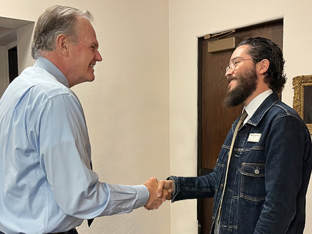 USD President Jim Harris shaking hands with former USD President for a Day, Miguel Hornedo