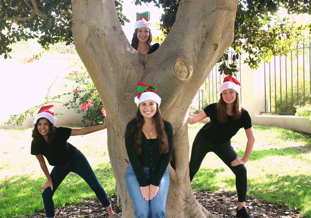 Founders Chapel Choir performers singing "Jolly Old St. Nicholas" near Founders Hall