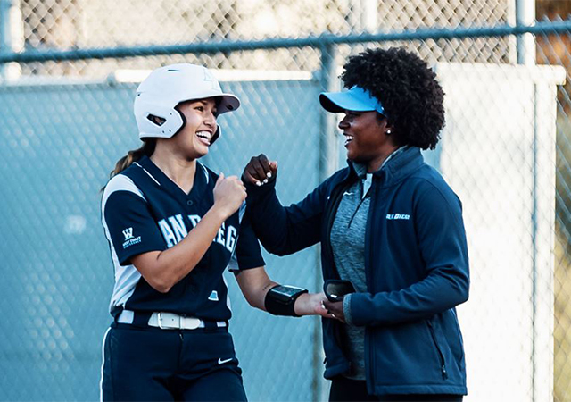 MJ Knighten, right, celebrates a hit during the 2020 USD softball season.
