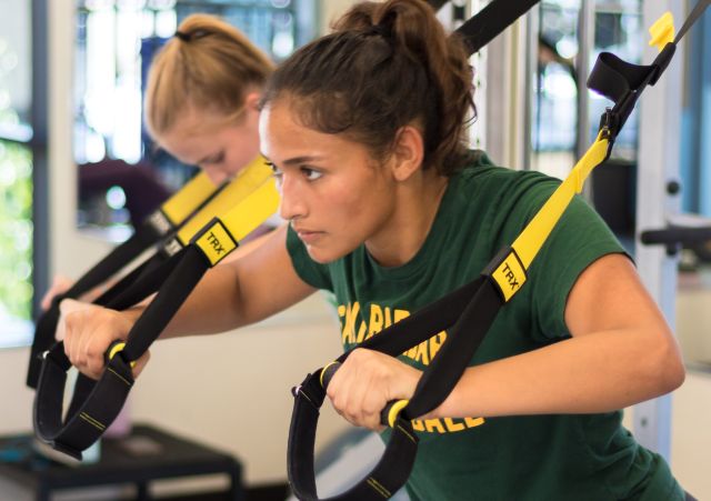 Student using TRX straps as part of a workout class