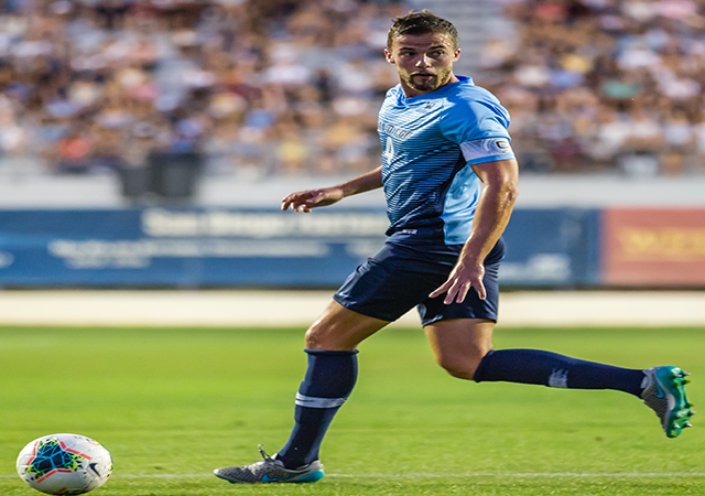 USD soccer player about to kick the ball