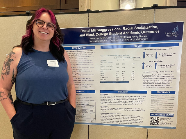 Alexandra Griffin standing to the left of her research poster