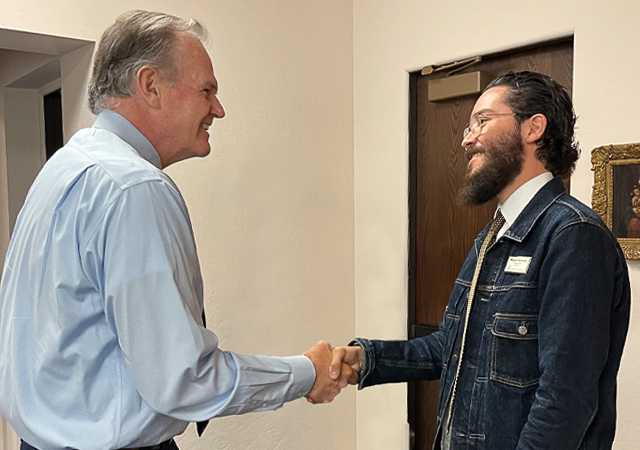 USD President Jim Harris and President for a Day Miguel Hornedo shaking hands