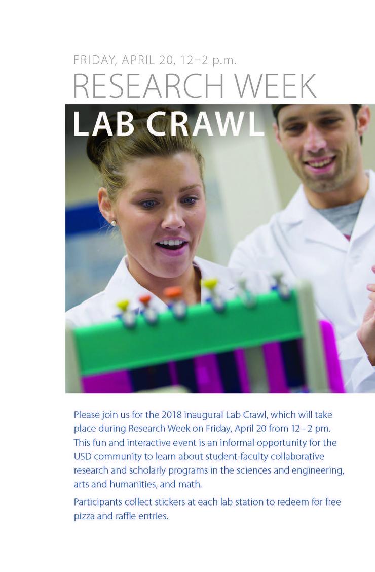 Two students smiling as they work in a lab.