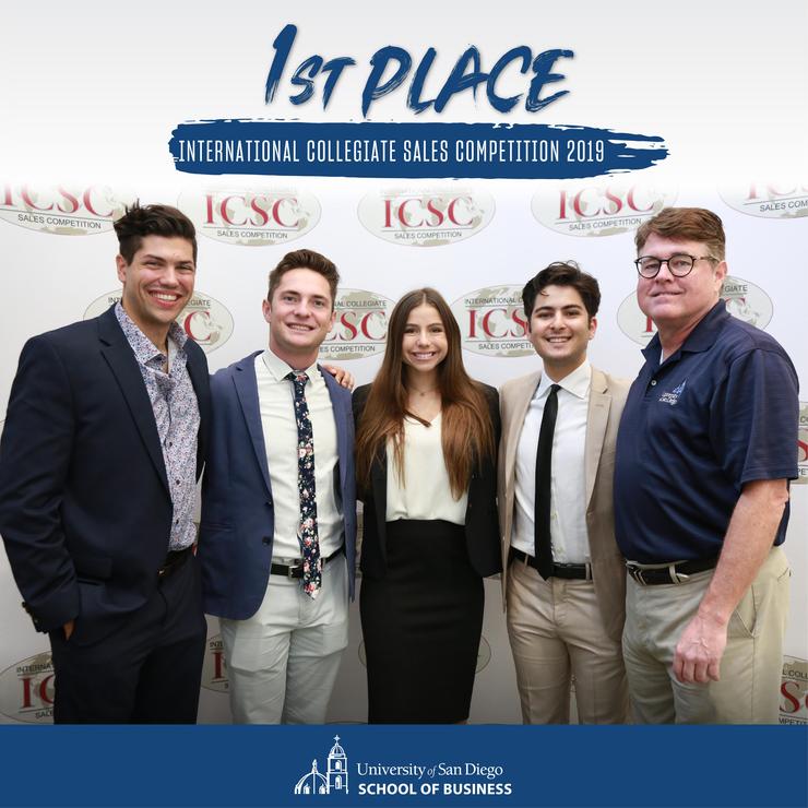 Two of USD's sales team members pose with their first place trophy at the International Collegiate Sales Competition
