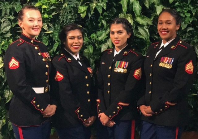 Lissette Nichols (third from left) stands smiling in her dress blues.