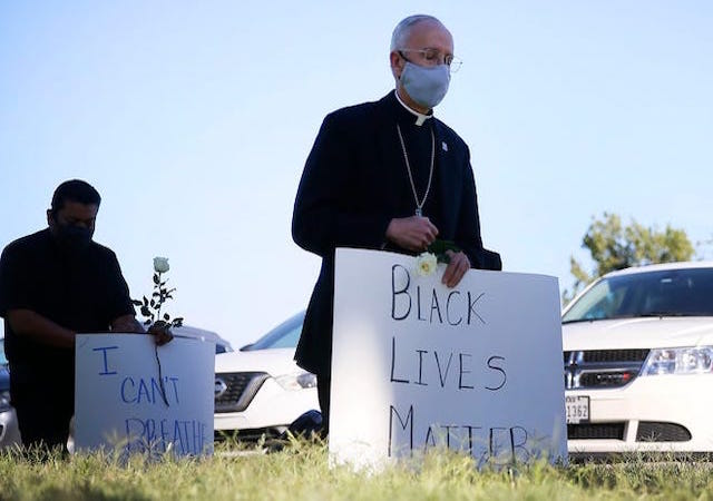 Bishop Seitz holding a Black Lives Matter Sign 