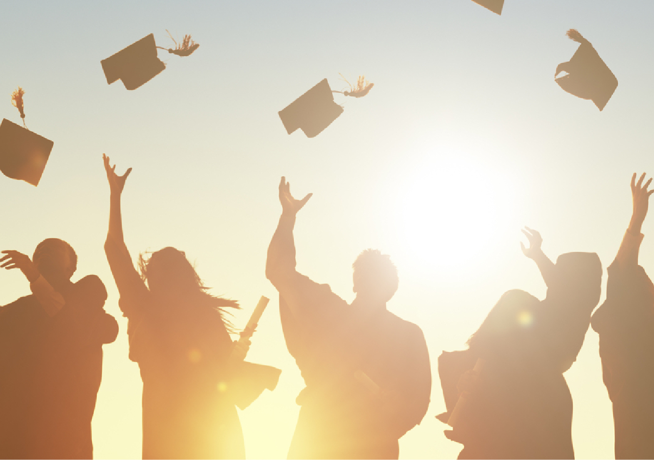 graduate students throwing caps in the air