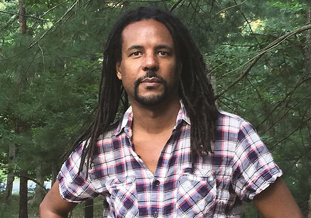 image of Colson standing in the middle of the woods