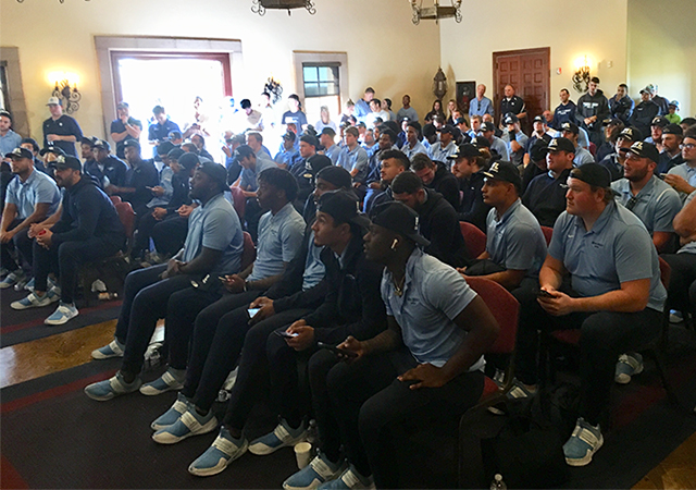 USD football players watch in anticipation of learning who they'll play in the first round of the FCS Playoffs.
