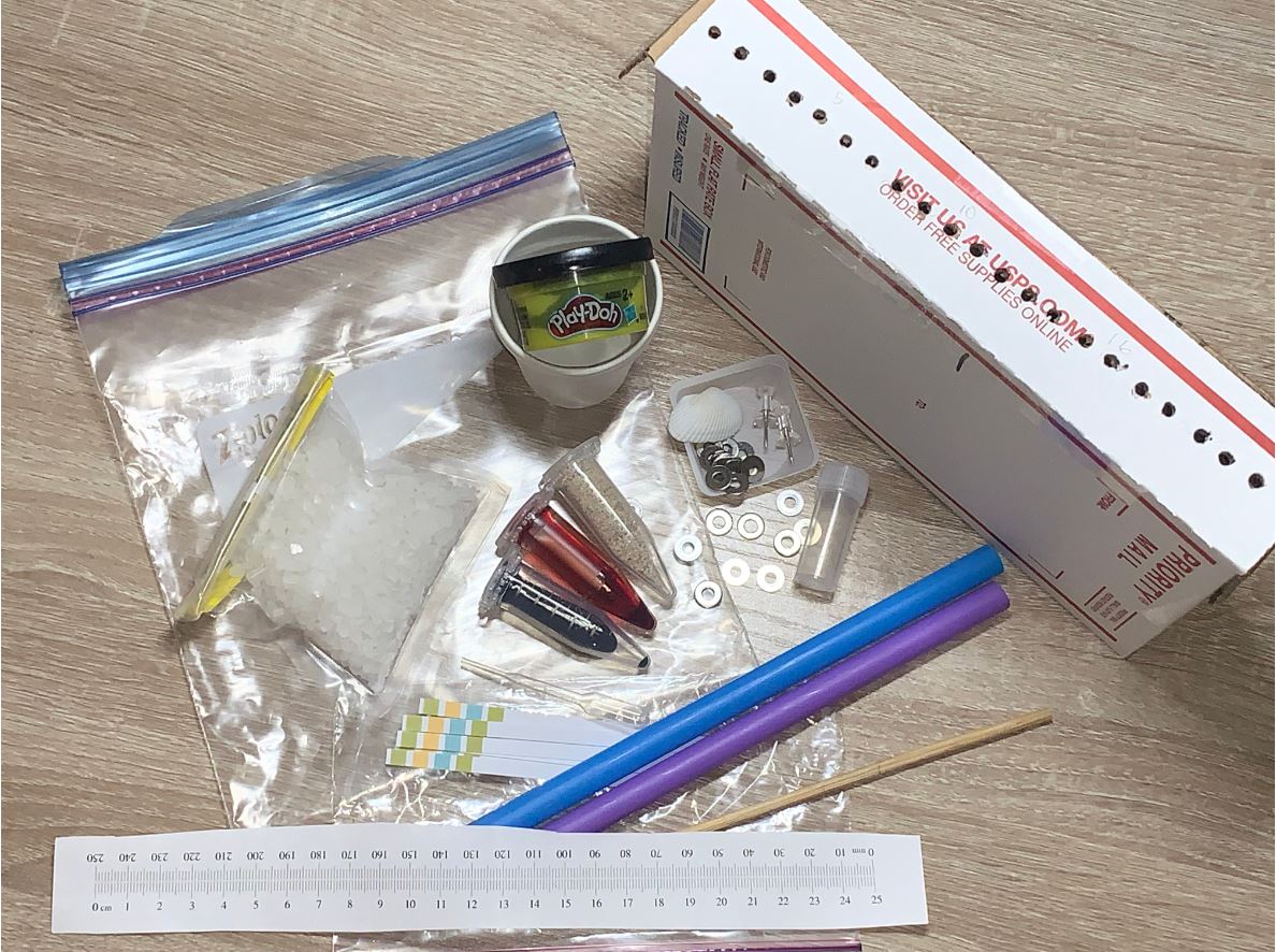 remote lab kits, including Play-Doh, straws, and vials of liquid.