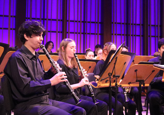 The USD Wind Ensemble performing on stage at the Conrad Prebys Performing Arts Center