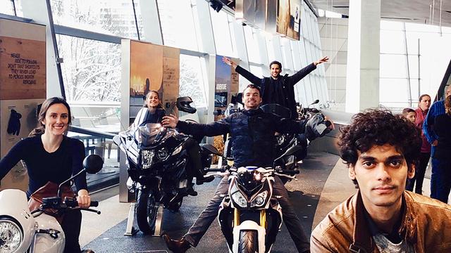 USD MBA students pose on motorcycles at BMW Motorrad