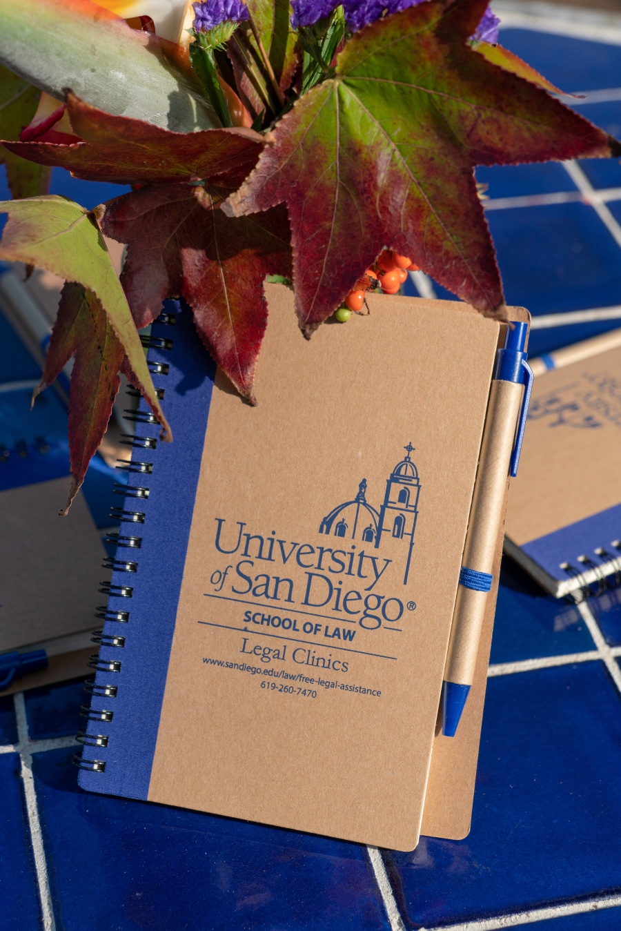 Notebook with USD School of Law Legal clinics logo on it